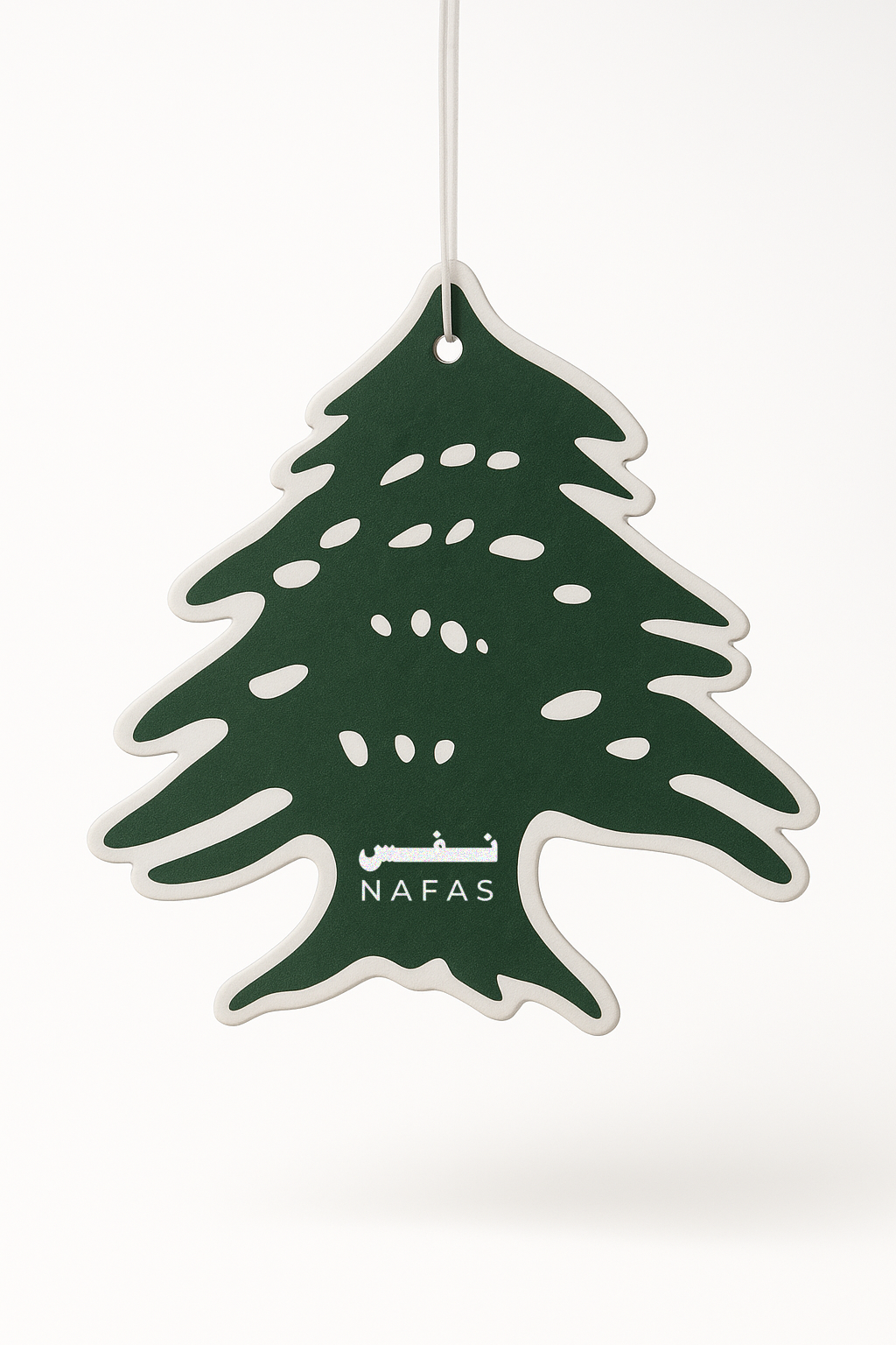 Lebanese cedar tree-shaped green Nafas scented paper air freshener hanging on a white background