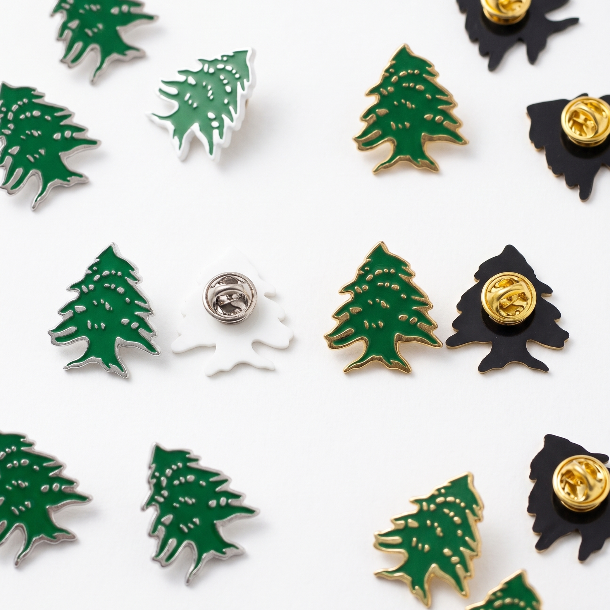 Multiple Lebanese cedar tree lapel pins in green and gold enamel
